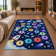 Navy galaxy hopscotch rug with colorful numbered planets, a rocket and astronaut, styled beside a sofa