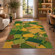 Patchwork Farm Fields Aerial rug in a living room with a desk and large windows