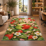 frog hugging a strawberry rug in a living room with a desk and large windows