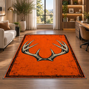 Blaze Orange Antlers rug in a living room with a desk and large windows