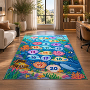 Blue ocean hopscotch rug with numbered bubbles, coral, fish and sea animals, shown in a sunlit room