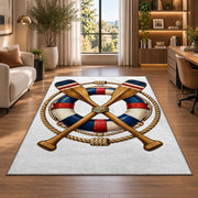 Crossed oars and life ring rug in a living room with a desk and large windows