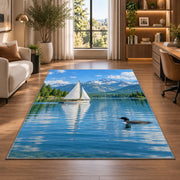 Sailboat and loon on lake rug in a living room with a desk and large windows