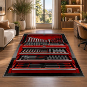 Red toolbox with open drawers rug in a living room with a desk and large windows