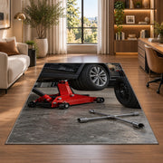 Car jack and spare tire rug in a living room with a desk and large windows
