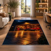 Garage at night with a muscle car rug in a living room with a desk and large windows