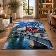 Semi truck crossing a steel bridge rug in a living room with a desk and large windows