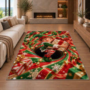 A smiling elf clutches a wrapped present while sitting inside a red and green spiral; rug shown in a neutral living room with size label