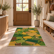 Patchwork Farm Fields Aerial rug in an entryway with a wooden door and bench