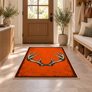 Blaze Orange Antlers rug in an entryway with a wooden door and bench