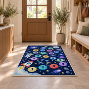 Navy galaxy hopscotch rug with colorful numbered planets, a rocket and astronaut, displayed in a cozy home interior