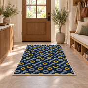Nuts and bolts pattern rug in an entryway with a wooden door and bench
