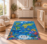 Blue world map rug with ocean animals and colorful coral in a nursery beside a crib