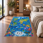 Blue world map rug with ocean animals and colorful coral in a bedroom beside the bed