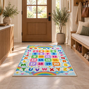 rainbow alphabet and numbers rug displayed in a entryway beside a wooden door