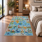 animal world map alphabet rug displayed in a bedroom beside the bed