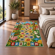 farm alphabet number trail rug displayed in a bedroom beside the bed