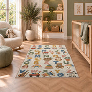 pastel alphabet objects rug displayed in a nursery beside an upholstered chair