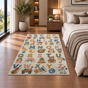 pastel alphabet objects rug displayed in a bedroom beside the bed