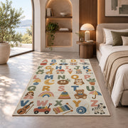 pastel alphabet objects rug displayed in a bedroom in sunlight