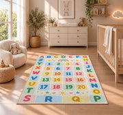pastel alphabet number grid rug displayed in a nursery beside a crib