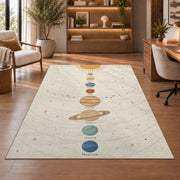 pastel planet orbit learning rug displayed in a living room with wooden shelves