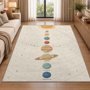 pastel planet orbit learning rug displayed in a sunlit lounge beside a sofa