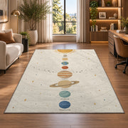 pastel planet orbit learning rug displayed in a lounge with wooden shelves