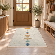pastel planet orbit learning rug displayed in a entryway beside a wooden door