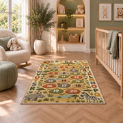 safari alphabet number trail rug displayed in a nursery beside an upholstered chair