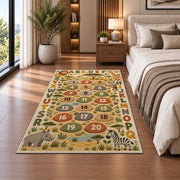 safari alphabet number trail rug displayed in a bedroom beside the bed