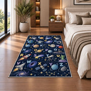 space alphabet adventure rug displayed in a bedroom beside the bed