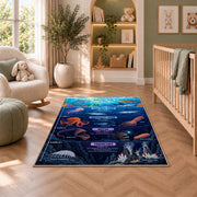 navy ocean layers learning rug displayed in a nursery beside an upholstered chair