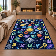 space alphabet number trail rug displayed in a living room with a fireplace