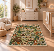 woodland alphabet number trail rug displayed in a nursery beside a crib