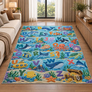ocean animal alphabet rug displayed in a sunlit lounge beside a sofa