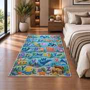 ocean animal alphabet rug displayed in a bedroom beside the bed