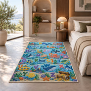 ocean animal alphabet rug displayed in a bedroom in sunlight