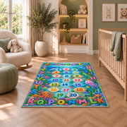 ocean alphabet number trail rug displayed in a nursery beside an upholstered chair