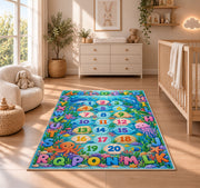 ocean alphabet number trail rug displayed in a nursery beside a crib