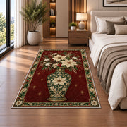 Poinsettia Porcelain Vase Christmas area rug in a bedroom beside the bed