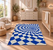 Blue Optical Checker Vortex area rug in a nursery beside a crib