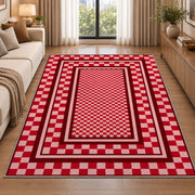 Red and Pink Checkered Border area rug in a living room beside a sofa