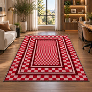 Red and Pink Checkered Border area rug in a home office beside a desk