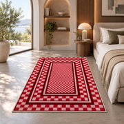 Red and Pink Checkered Border area rug in a bedroom with an arched window