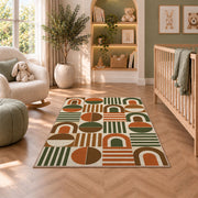 Retro Arch Geometric area rug in a nursery with a crib and armchair
