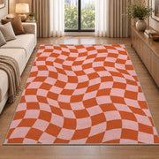 Wavy Orange and Pink Checkerboard area rug in a living room beside a sofa