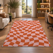 Wavy Orange and Pink Checkerboard area rug in a home office beside a desk