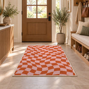 Wavy Orange and Pink Checkerboard area rug in an entryway