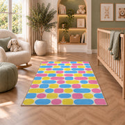 Pastel Pill Pattern area rug in a nursery with a crib and armchair
